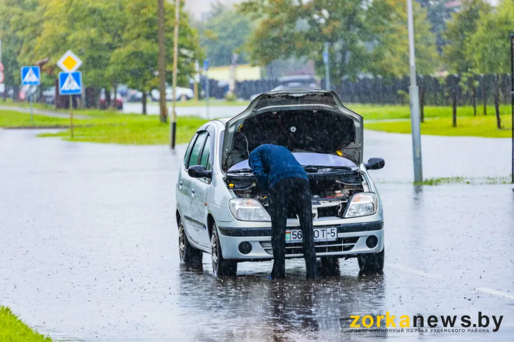 водитель ремонтирует автомобиль
