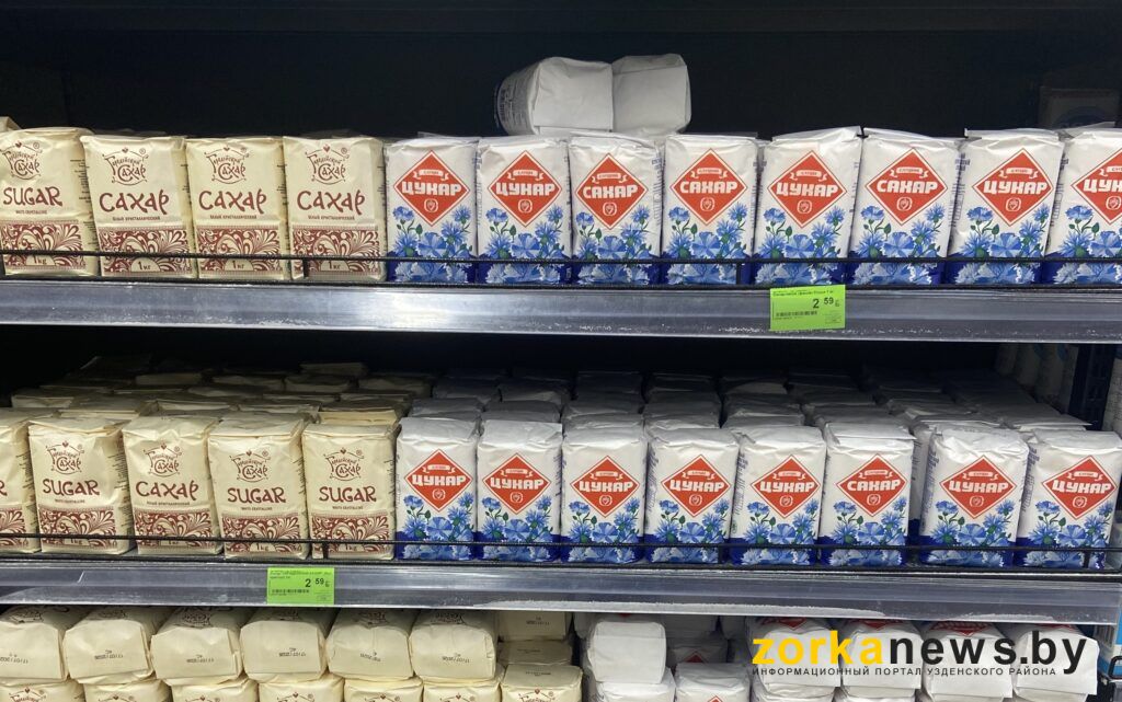 сахар цукар магазин полка супермаркет упаковка пачка белый сладкий продукт бакалея товар стеллаж ценник дефицит торговля покупка килограмм сахарный